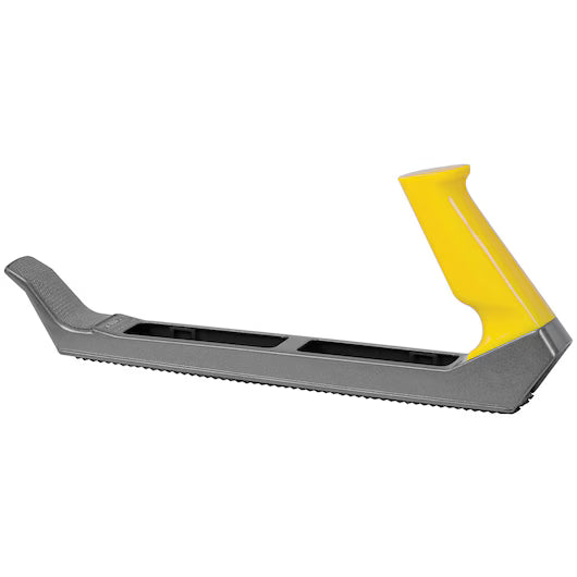 The STANLEY 10 IN SURFORM® PLANE TYPE REGULAR CUT BLADE is shown from the side on a white background, fitted in a gray and yellow plastic knife sharpener with a handle and blade insertion slot.